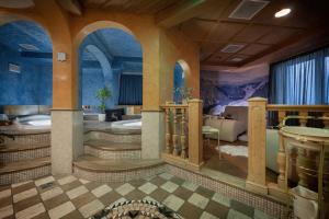 a large bathroom with a tub and a sink at Bio Hotel Villa Cecilia in Livigno
