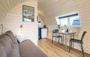 a room with a couch and a table and a kitchen at Awesome Home In Skjern in Skjern