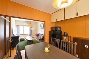 a kitchen and living room with a table and a dining room at Shion 潮音 in Sakaide