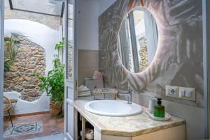 a bathroom with a sink and a mirror at Cozy guest house Downtown in Olbia