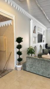 a living room with two potted plants and a couch at منتجع اغصان الشفا in Ash Shafa +21 photos