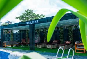 a pavilion with chairs and a sign that reads pool bar at Ocean Front Hotels Enugu in Awkuzu