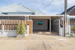 a house with a gate in front of it at The Comfy House Prachuap in Sathani Rot Fai