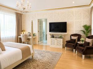 a bedroom with a bed and a flat screen tv at Rose Amer in Jaipur