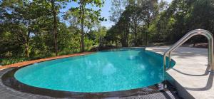 an empty swimming pool with a metal rail around it at Tamarind Tamarind Resort, Tourist Board Approved in Habarana