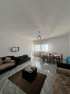 a living room with a couch and a table at Maison vue mer in Rafrāf