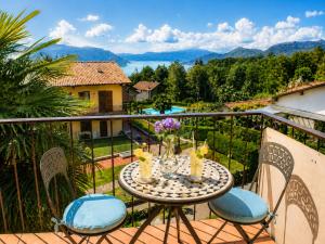 a table and chairs on a balcony with a view at Residenza Paradiso in Agra +5 photos