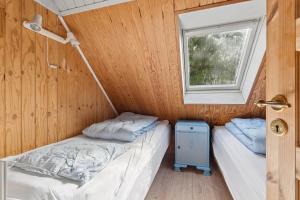 two beds in a small room with a window at Charming 45 M House In Peaceful Setting in Gelsted