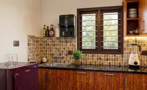 a kitchen with a sink and a counter top at Urban Escape in Cochin +7 photos