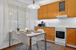 a kitchen with a table and chairs in it at Cozy two-room apartment with sauna in Sodankylä