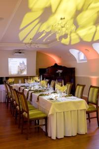 a dining room with a long table with wine glasses at Hotel Bojnický vínny dom in Bojnice