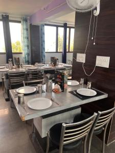 a restaurant with several tables and chairs with sinks at Hotel AAA And Restaurant in Gupta Kāshi +51 photos