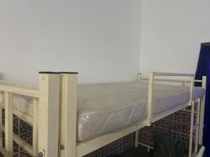 a bunk bed with a mattress on top of it at Turkish Muscat hostel in Muscat