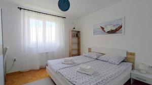 a bedroom with a bed with two towels on it at Apartma Breza in Kojsko