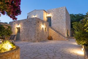 a stone building with a stone patio and stairs at Mainotti's house in Areopoli