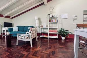 a living room with a blue couch and a book shelf at BoscoLago apartment Lake Iseo & Franciacorta in Iseo