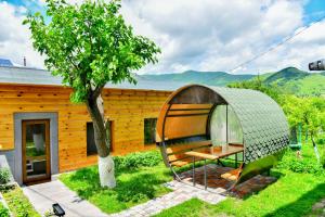a pod house in a garden with a tree at Hayi Tun Guest House in Goris