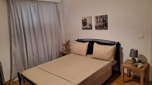 a bedroom with a bed and a window at Central Location in Nafplio