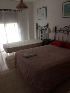 Łóżko lub łóżka w pokoju w obiekcie Apartamento Mateos