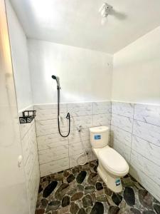 a bathroom with a toilet and a shower at Kaffana Cabin House in Banjarnegara