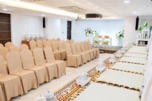 a row of chairs in a room with white tables at Christella Hotel Laemchabang in Si Racha +97 photos