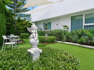 a statue in the yard of a house at Christella Hotel Laemchabang in Si Racha