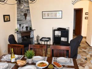 a dining room with a table and a fireplace at Sogno dOro in Germignaga