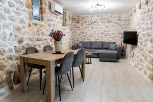 a living room with a table and chairs and a couch at Mainotti's house in Areopoli