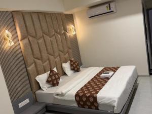 a hotel room with a bed in a room at Hotel Runway in Vadodara