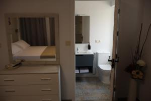a bathroom with a bed and a sink and a toilet at Hostal el Ciervo in Burunchel +60 photos