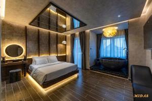 a bedroom with a bed and a bath tub at Midas Hotel 2 in Ho Chi Minh City +23 photos