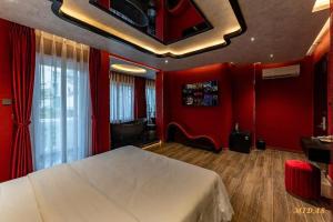 a bedroom with red walls and a bed in a room at Midas Hotel 2 in Ho Chi Minh City