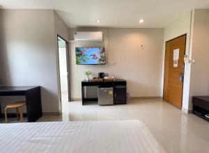 a hotel room with a bed and a desk in it at U Dee Room and Coffee in Kanchanaburi City