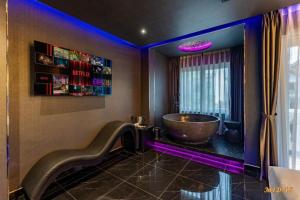 a bathroom with a large tub in the corner of a room at Midas Hotel 2 in Ho Chi Minh City