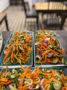 three trays of different vegetables on a table at Sost Embassy Hotel By Zeez in Khudābād +15 photos