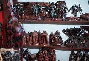 a shelf filled with lots of wooden utensils at INTAGARA Handcrafts in Butare
