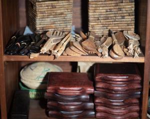 a shelf filled with lots of shoes and other items at INTAGARA Handcrafts in Butare