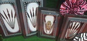 a group of four wooden picture frames with a pair of shoes at INTAGARA Handcrafts in Butare