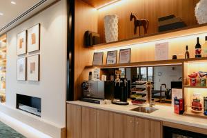 a store with a counter with a coffee shop at Punthill Epping in Epping