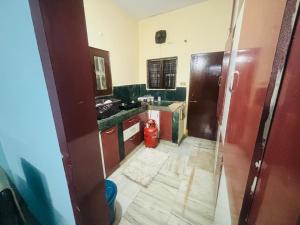 a kitchen with a red fire hydrant in a room at Lara Homestay 2bhk in Secunderabad
