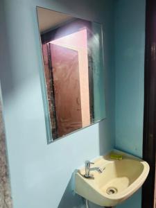 a bathroom with a sink and a mirror at Lara Homestay 2bhk in Secunderabad
