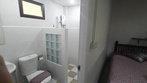 a small bathroom with a toilet and a sink at Lamphun Garden Home in Lamphun +26 photos