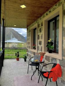 a patio with a table and a laptop on it at Kazbegi Vibe in Kazbegi