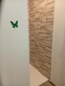 a butterfly decoration on a wall in a bathroom at Chambre familiale in Voutré +1 photo