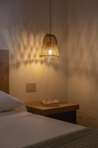 a bedroom with a bed and a table with a lamp at Orsola Apartments in Favignana +54 photos