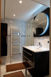 a bathroom with a sink and a mirror at Chambres d'hotes à Autun in Autun +42 photos