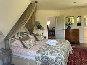 a bedroom with a bed with two pillows on it at L'Oisette in Epiniac +150 photos