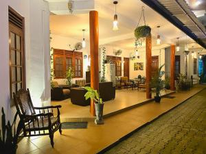 a lobby of a building with chairs and plants at Seven Minutes Ella by SANS in Ella