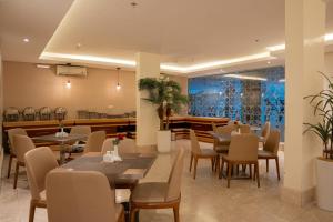 a dining room with tables and chairs in a restaurant at Al Muhaidb Residence Al Takhasossi 2 - Economic in Riyadh