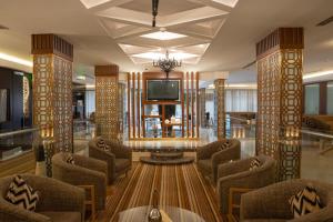 a lobby with chairs and a tv in a building at Al Muhaidb Residence Al Takhasossi 2 - Economic in Riyadh
